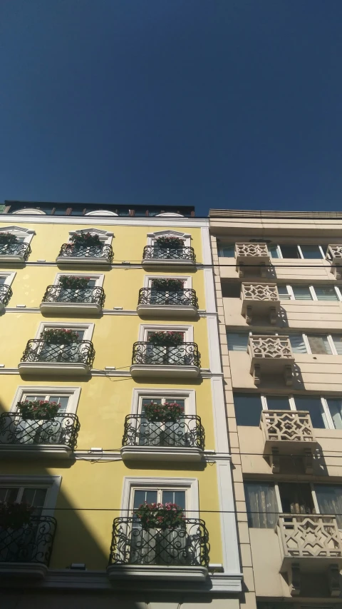 a very tall building with lots of balconies on the windows