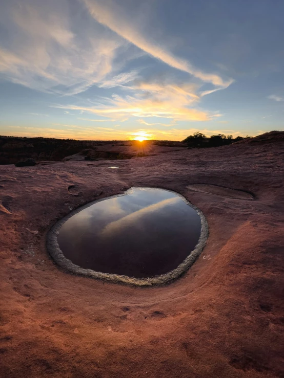 a pond in the middle of a barren field