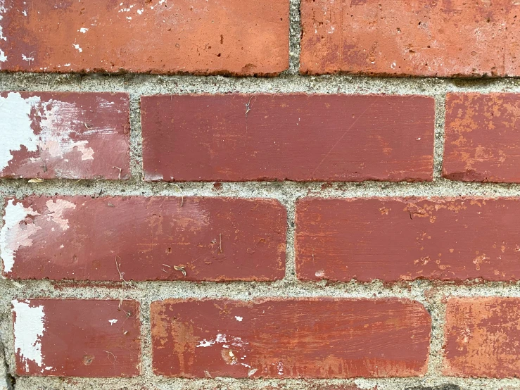 a fire hydrant is plugged in to a brick wall