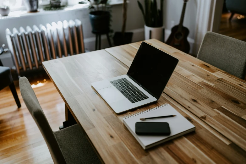 a desk top with an open laptop sitting on it