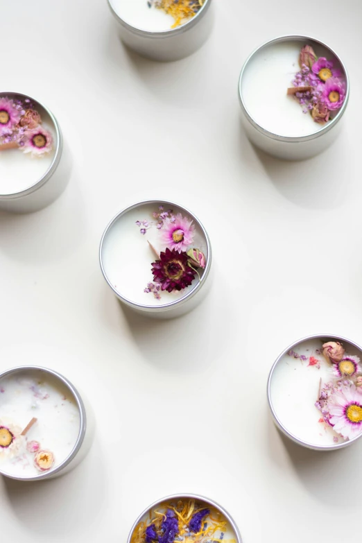 a bunch of food in bowls with flowers