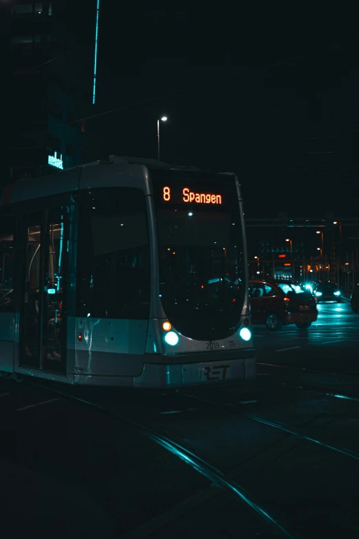 a city bus on a street at night