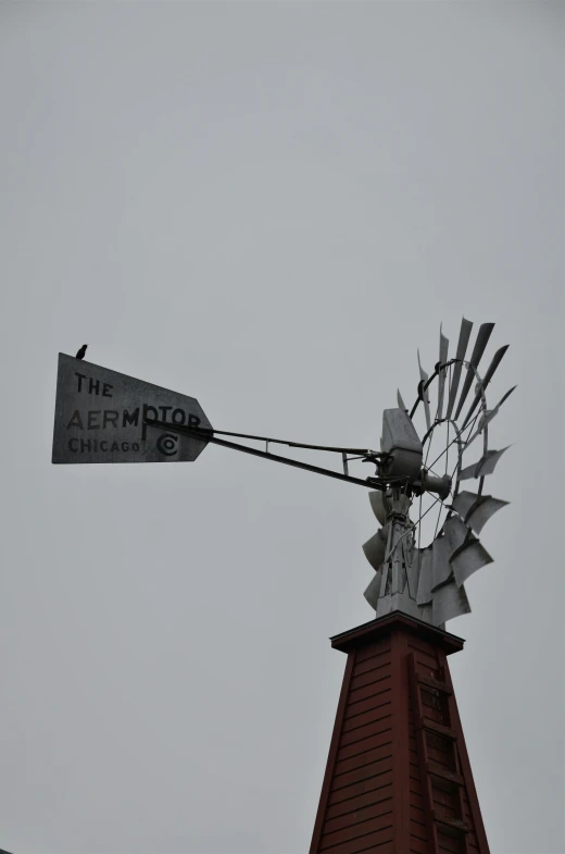 windmill with street sign sitting on top of building