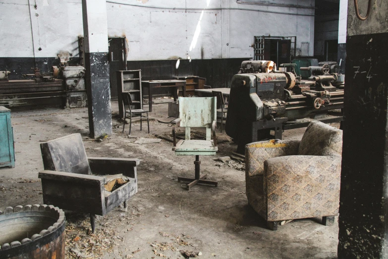 a bunch of chairs in an old warehouse