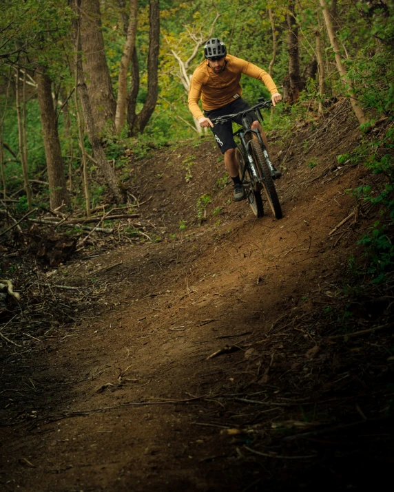 a person riding on the side of a mountain bike