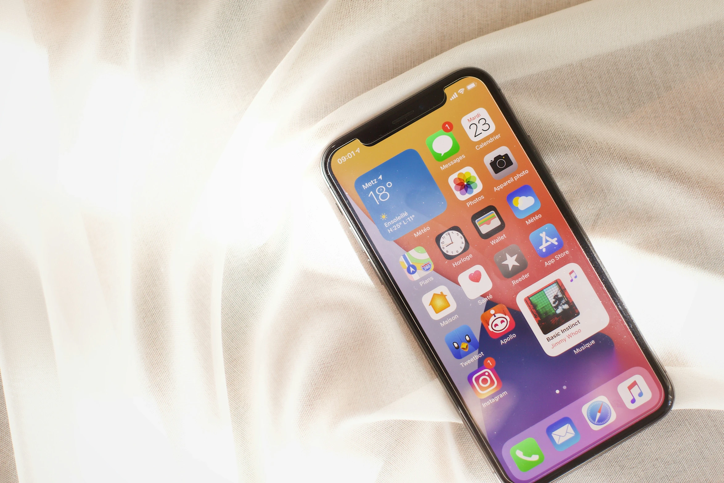 an iphone sitting in front of some white sheets