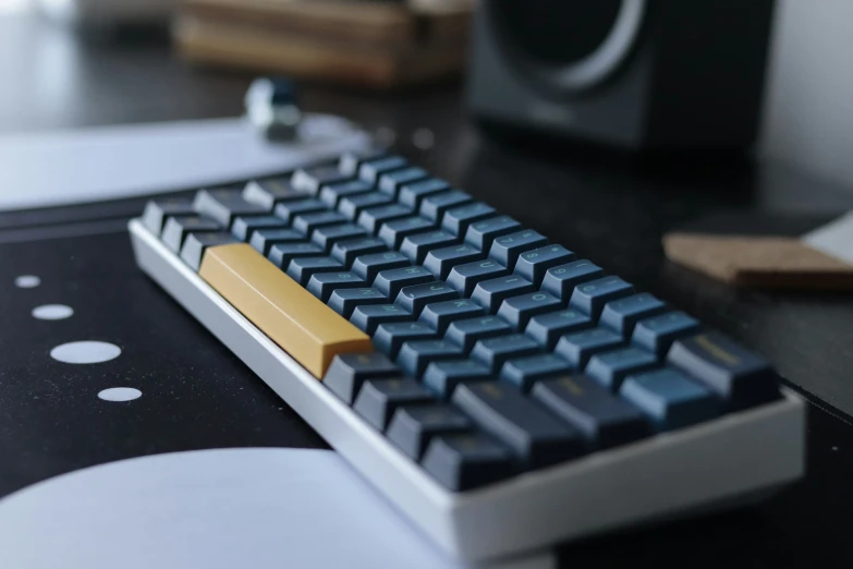 a computer keyboard with an orange and black strip on top