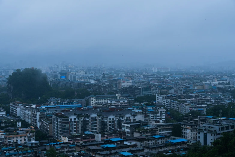 the skyline of the city, with blue roofs, stands over the hill