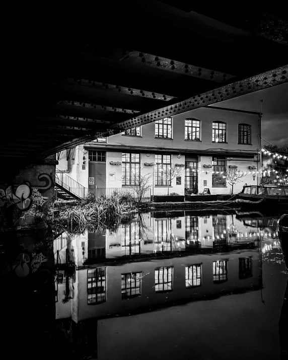 a large building sitting above water at night