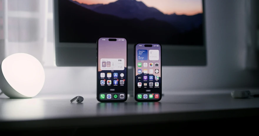 two smart phones sit next to each other on a table