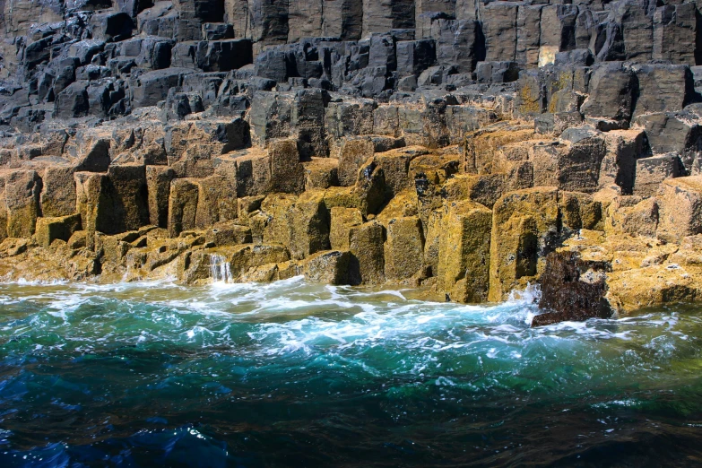 rocky coastline covered in ice and rocks near water