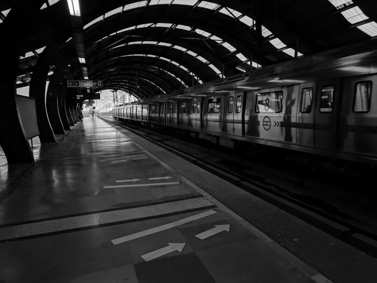 the subway is in a very long and empty station