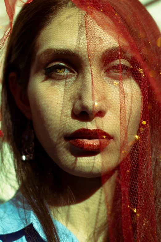 a young woman with a veil around her face