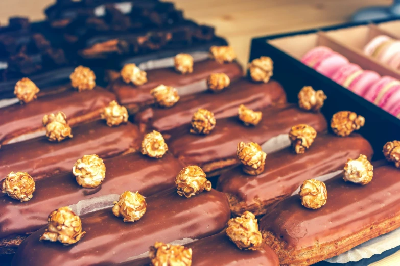 a large tray of chocolate covered donuts and other desserts