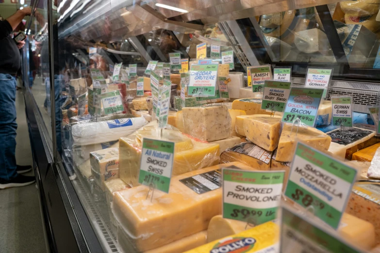 several boxes of cheese behind a glass window