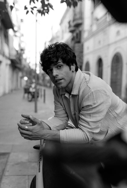 a man leaning on a wall on a city street