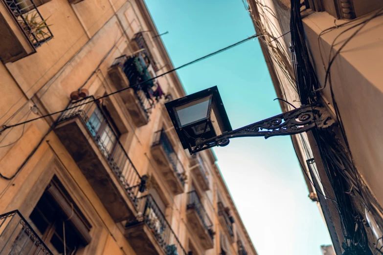 the street light has two street signs hanging off of it's sides