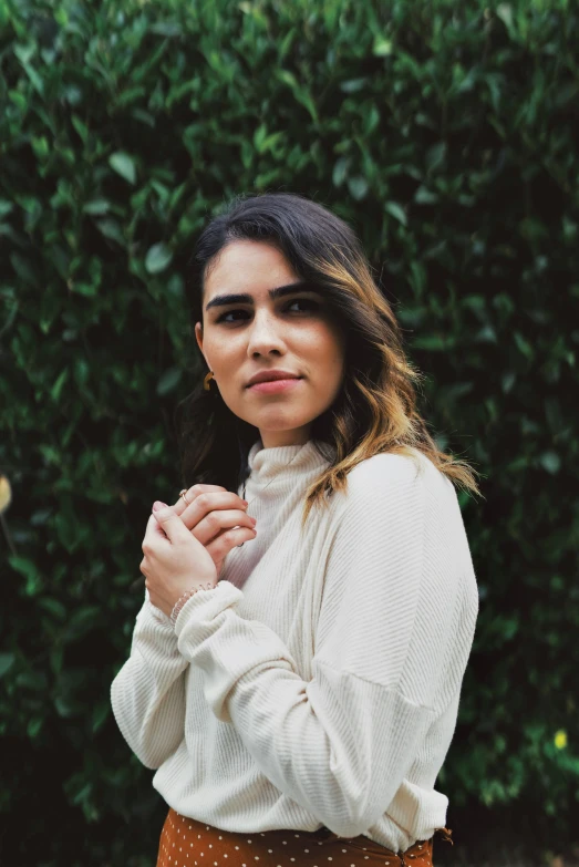 an image of a woman that is standing with her hands crossed