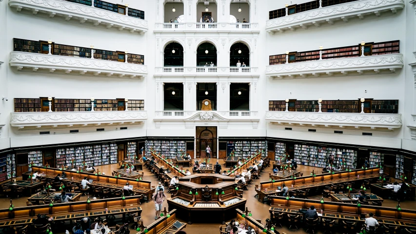 view from first floor of a large liry with people reading