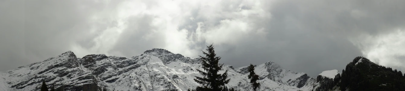 there are some mountains with snow and clouds