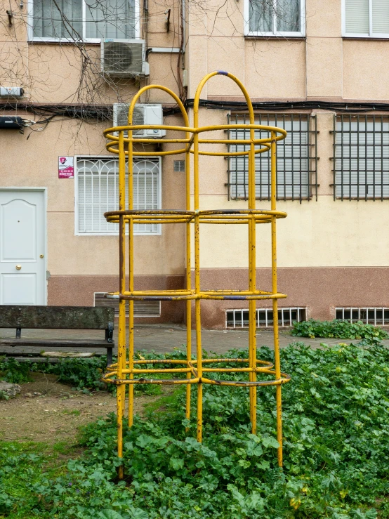 a yellow tower sitting in front of a building
