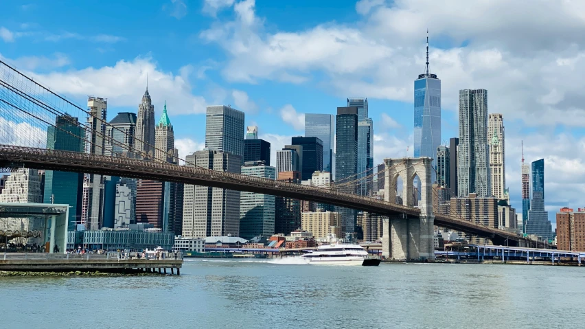 a boat under a bridge on a large body of water