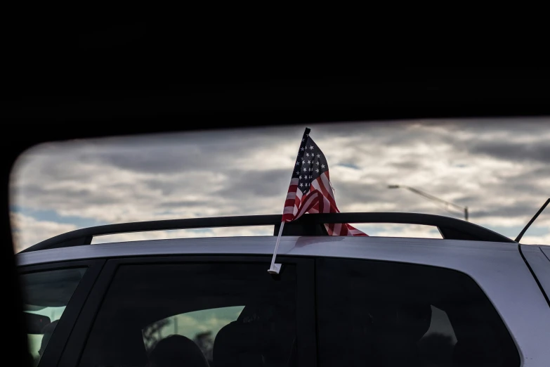 an american flag sitting on top of the back of a truck