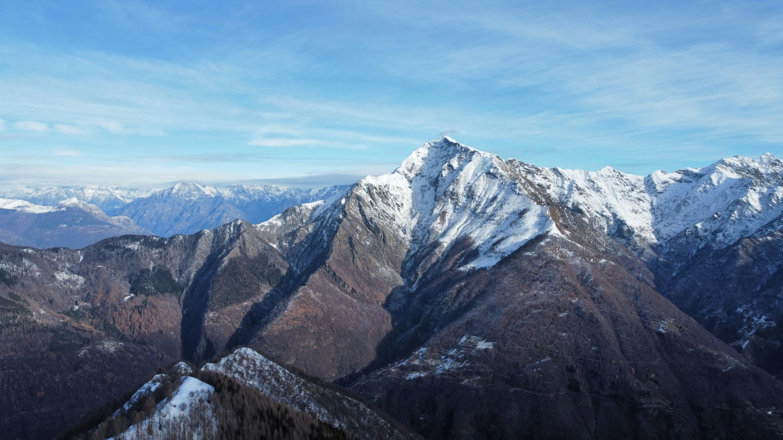 the tops of mountains with snow on them