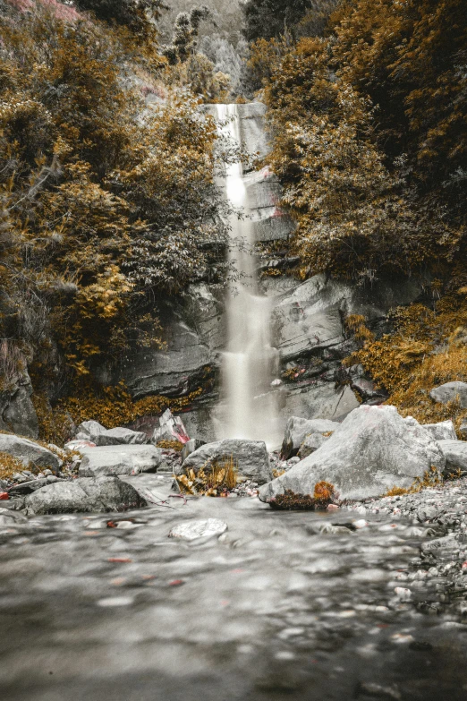 an artistic image shows the waterfall and rocks in the foreground