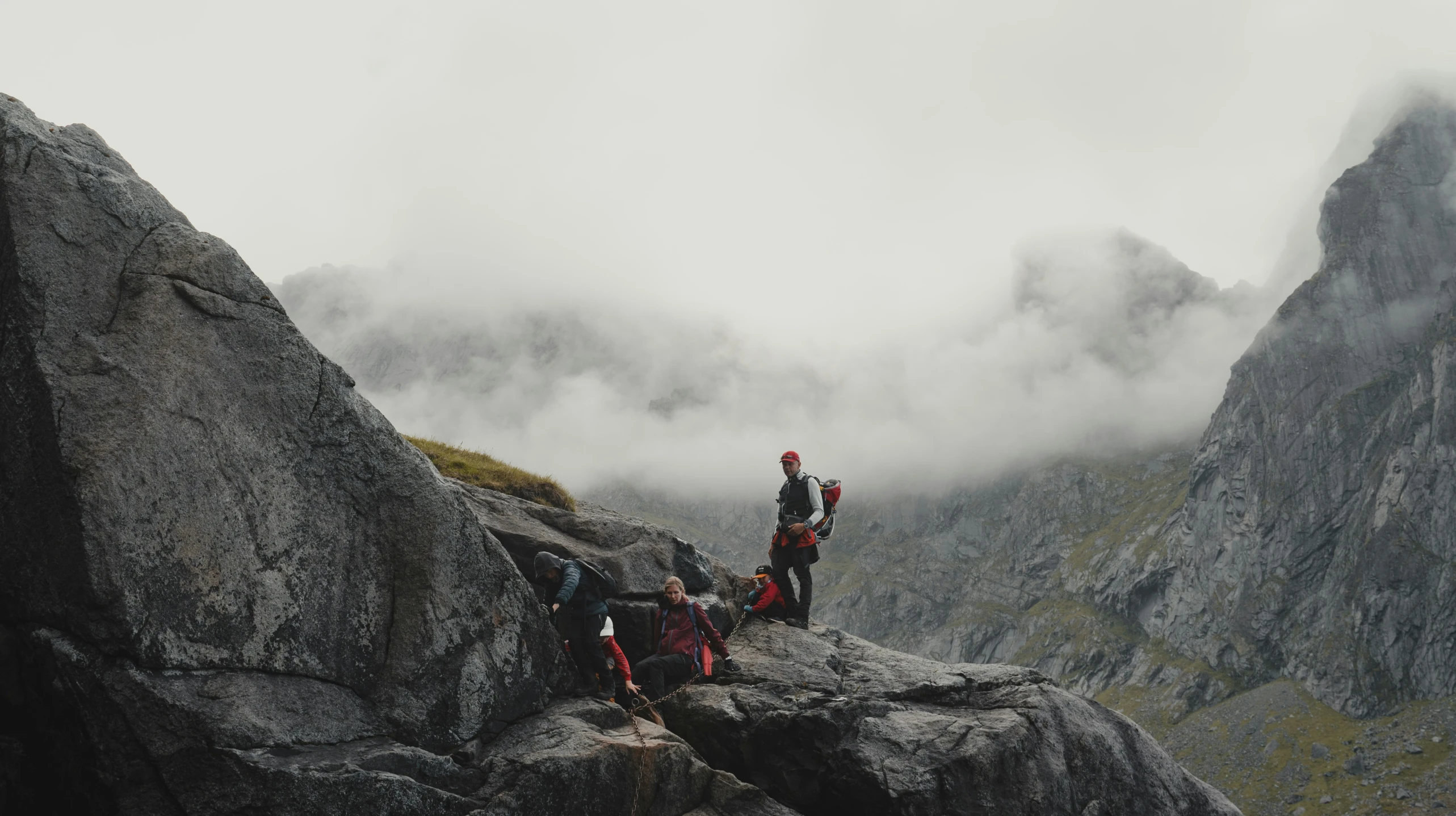 a couple hikers with a backpack on a cliff