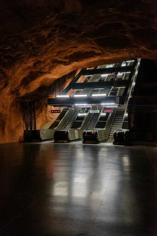 a pair of empty stairs that are lit up in an open area