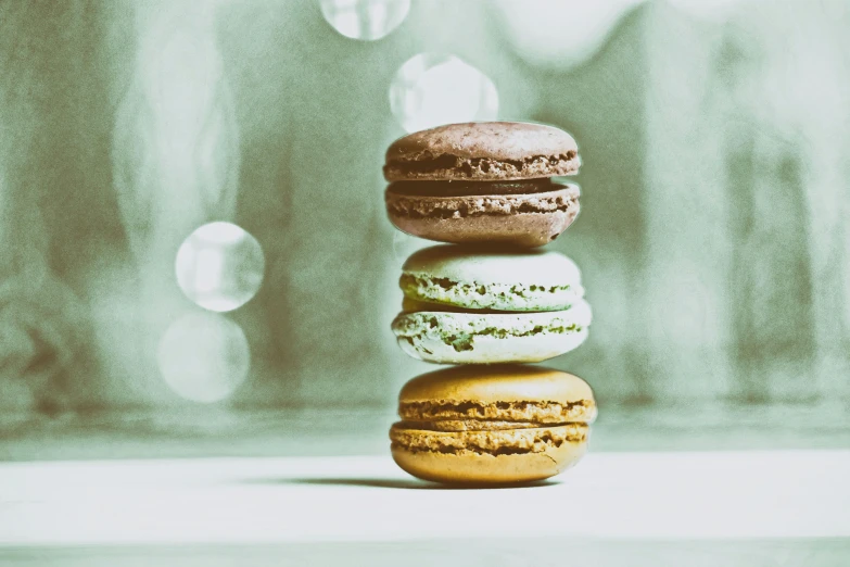 three macaroons on a white surface with a blurry background