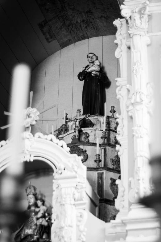 a large white statue with a cross above it