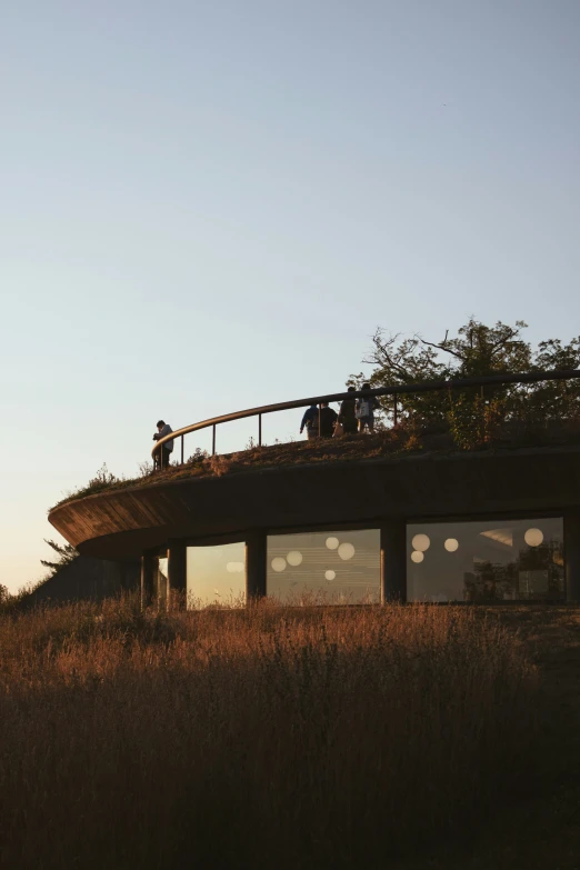 a couple of people are on top of a house