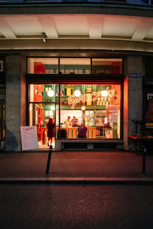 a store front is illuminated by neon light