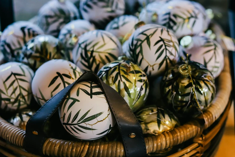 a basket full of decorated easter eggs on a table