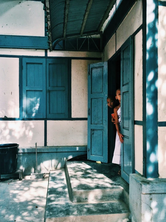 a young couple is opening a door on the porch