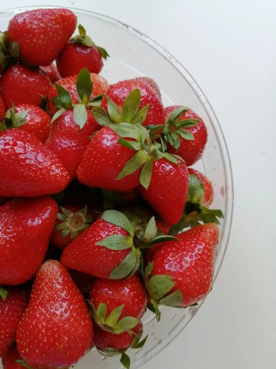 a bunch of strawberries are sitting in a bowl