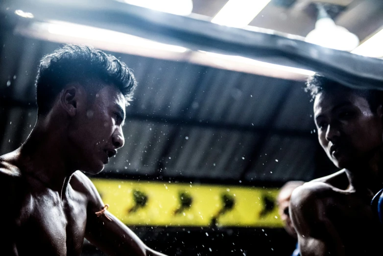 two men boxing in an indoor gym