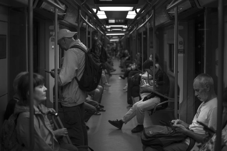 people are sitting on the subway train