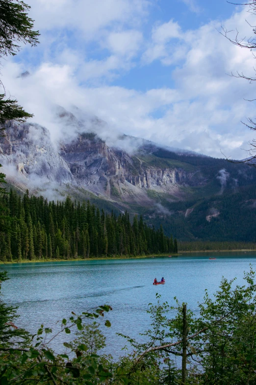 the boat floats along a scenic lake in the mountains