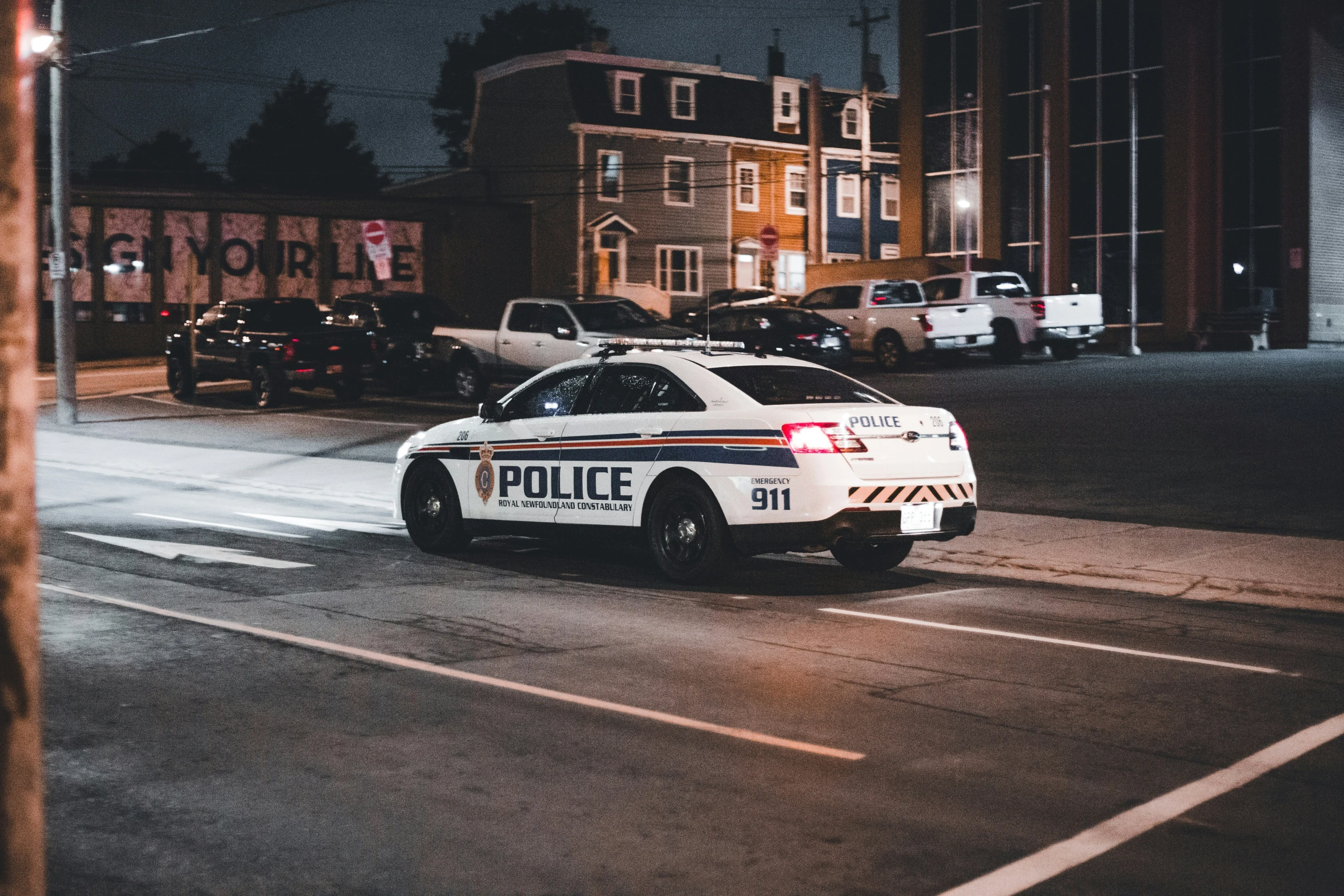 the police car is parked in the lot by the building