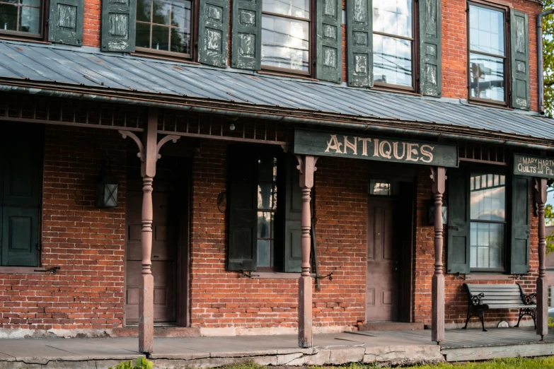 the front porch and front door of an antique brick building