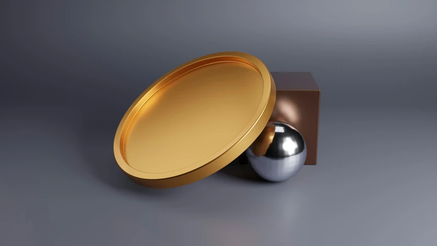 a silver ball sitting inside a golden cardboard box