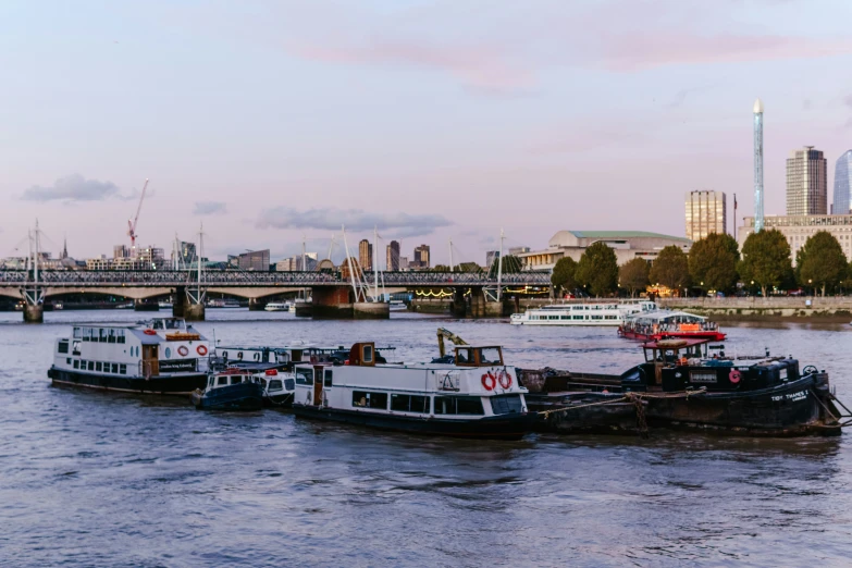 a number of small boats floating on top of a river