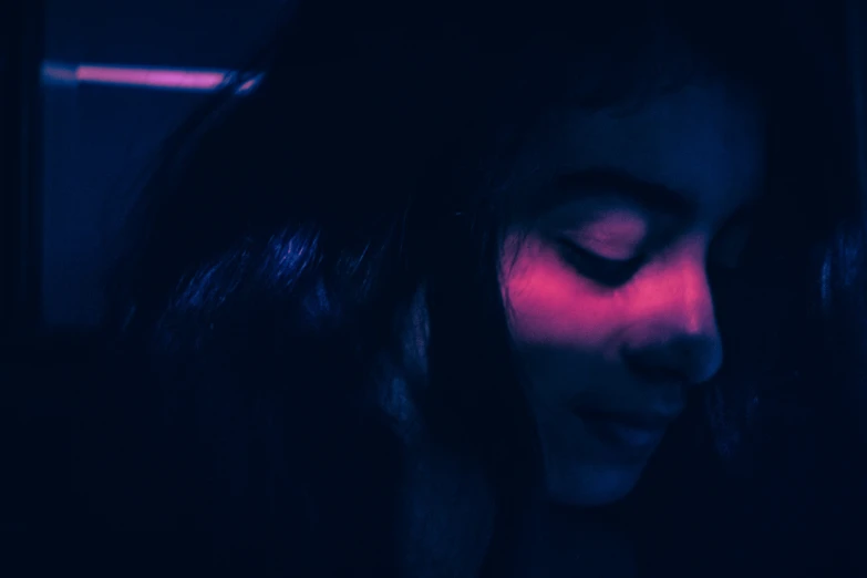 a woman with long dark hair has red light