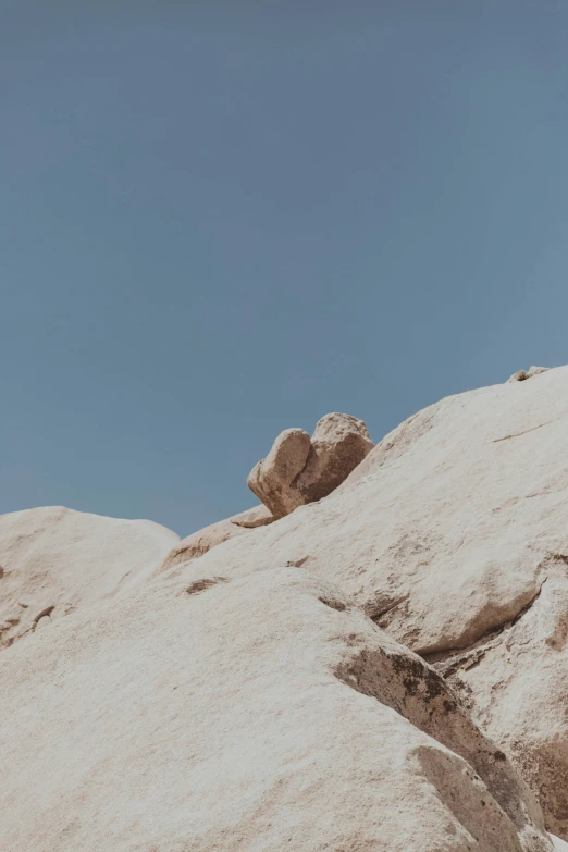 a man standing on top of a large rock