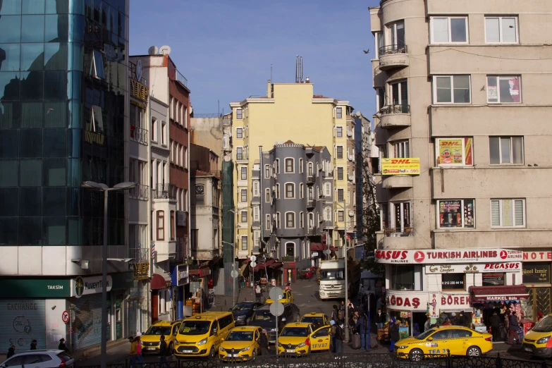 several yellow taxi cabs on street in large city