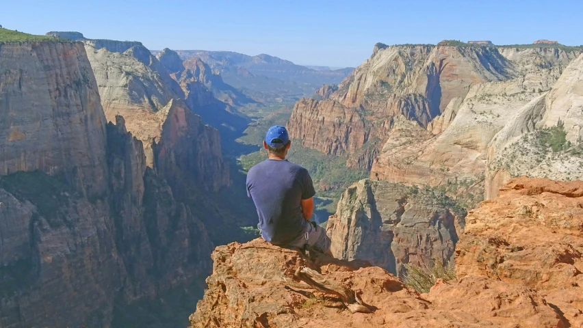 there is a man that is on top of a cliff