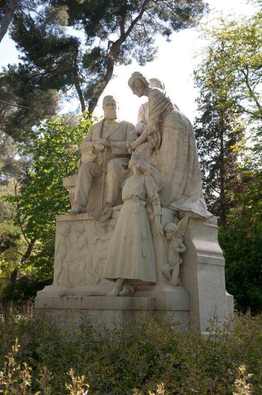 several statues are arranged at the base of a tree